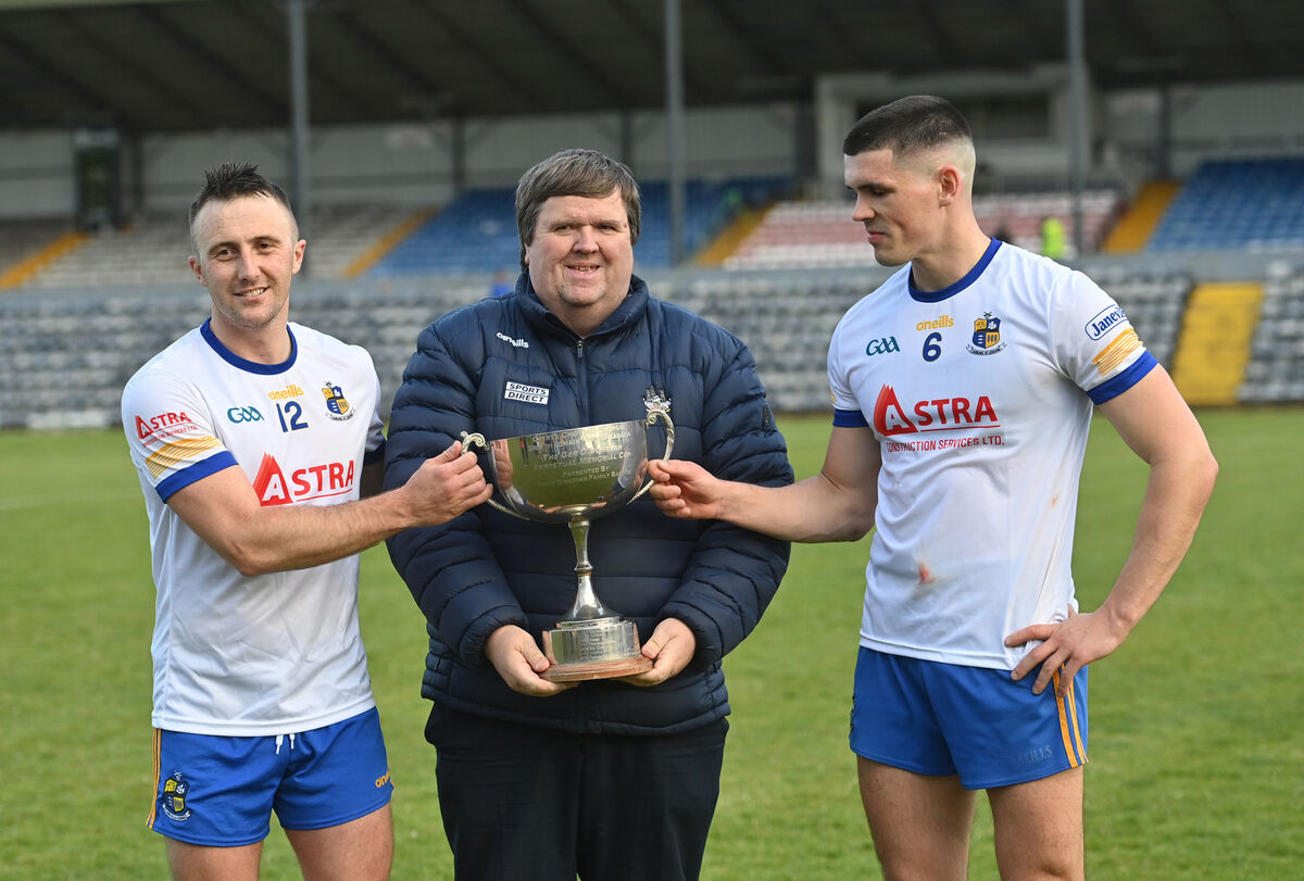  Carrigaline joint captains Rob O'Shea and David Griffin are presented with the RedFM Hurling League Division 2 trophy by Derek Connolly. Picture: Dan Linehan