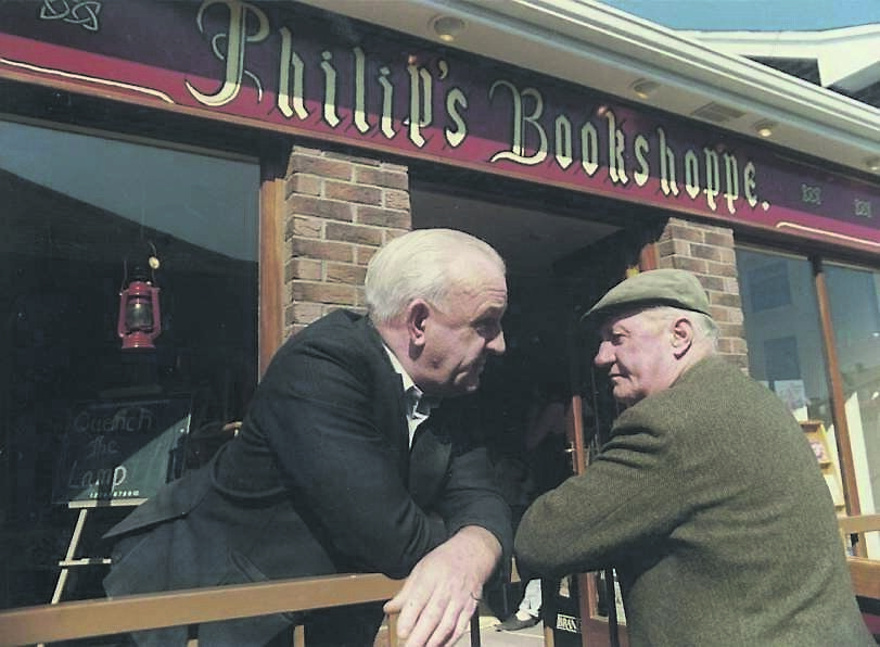Men chatting outside a bookshop in Mallow. 	Picture: Gerard O’Meara
                    