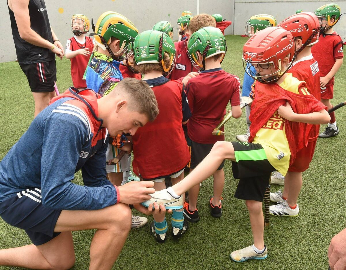 Jack Shanahan has his boot signed by Castlemartyr and Cork player Ciarán Joyce. Photo: George Hatchell.