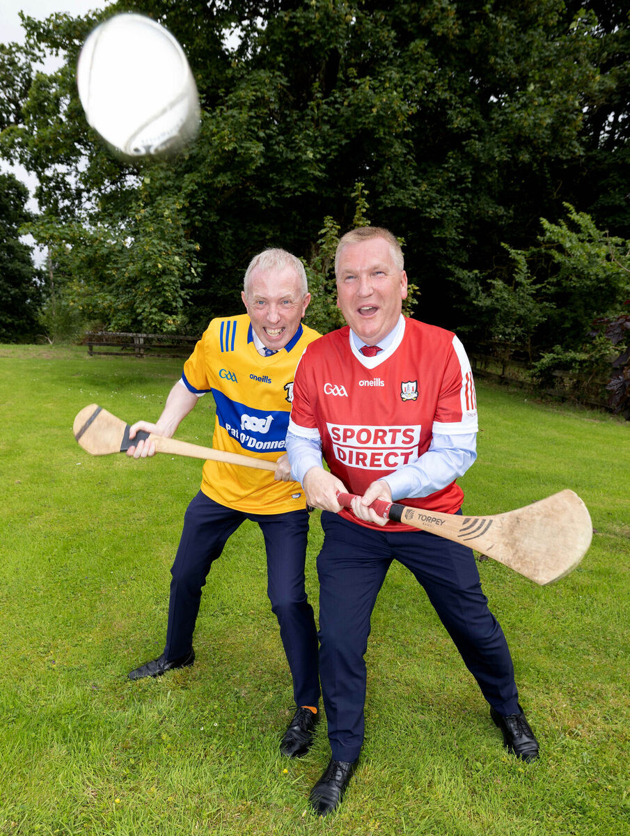 When two tribes go to war! Even the FF family is split down the middle by hurling this weekend, with Clare Senator Timmy Dooley (left) and Commissioner-designate Michael McGrath warming up for Sunday’s decider in Croke Park with a little throw-in taster of their own. Pic: Arthur Ellis