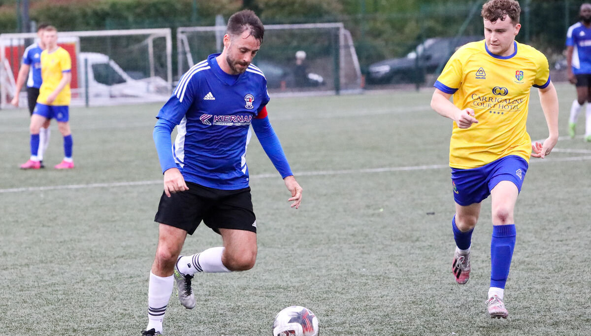 Wilton's Ian Roche about to be tackled by Ronan Connolly during the 2nd round of the Sports Direct FAI Cup game between Carrigaline United and Wilton United that was played at Ballea Park, Carrigaline, Co. Cork. - Picture: David Creedon