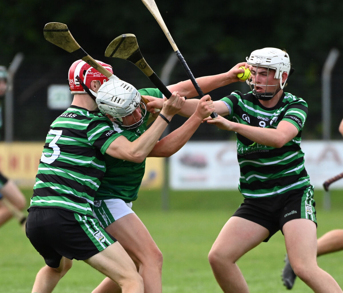 Ballincollig's Cian Ahern is tackled by Douglas' Liam Kelleher and William Banks during the Premier 1 MHC , round 1 at Ballincollig . Picture: Eddie O'Hare