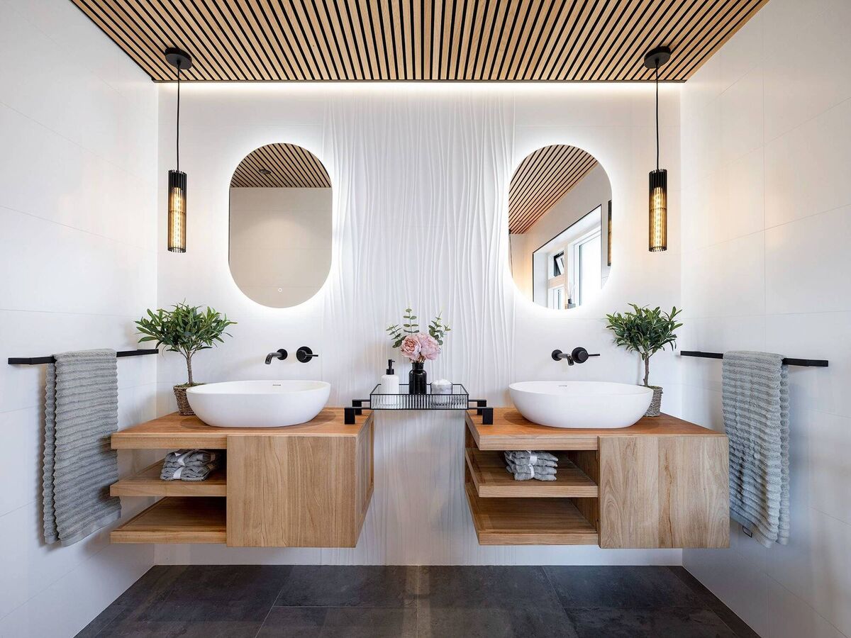 Combining the elements of wood, ceramic tiles and a sophisticated lighting scheme, this recently renovated bathroom exudes spa-like luxury