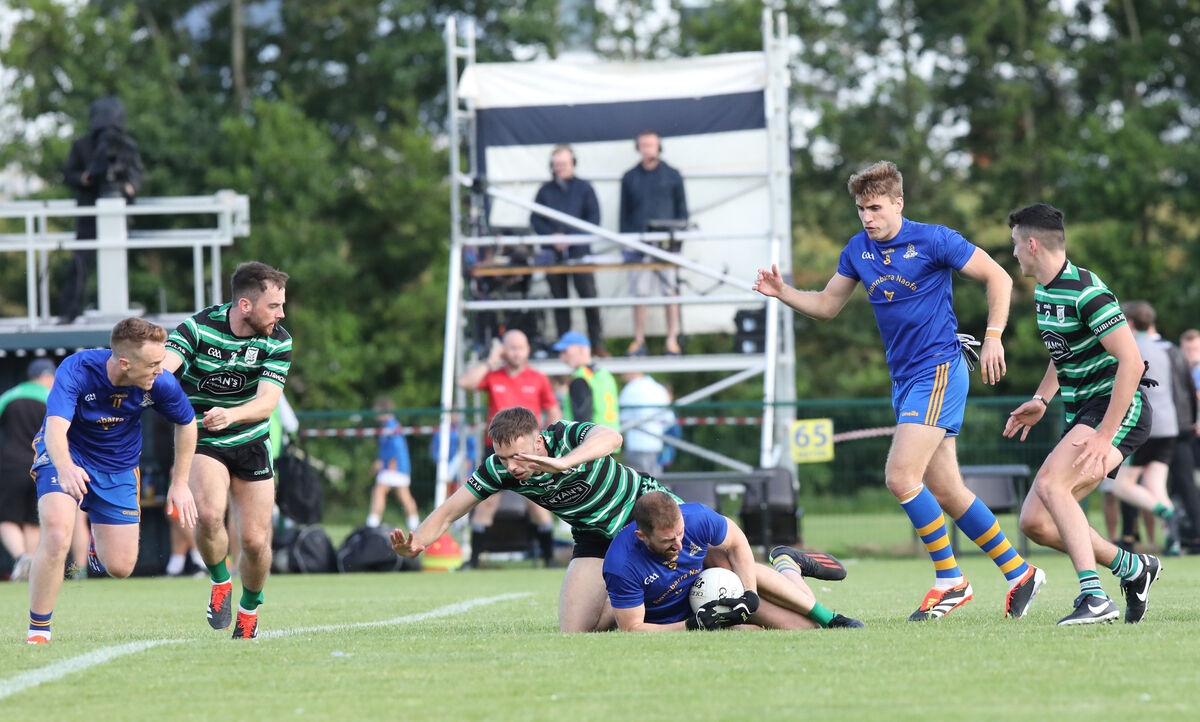 Jamie Burns of St Finbarr's and Douglas's Kevin Shanahan scrap for the ball on the ground during the McCarthy Insurance Group Cork Premier SFC game in Carrigaline. Picture: David Creedon