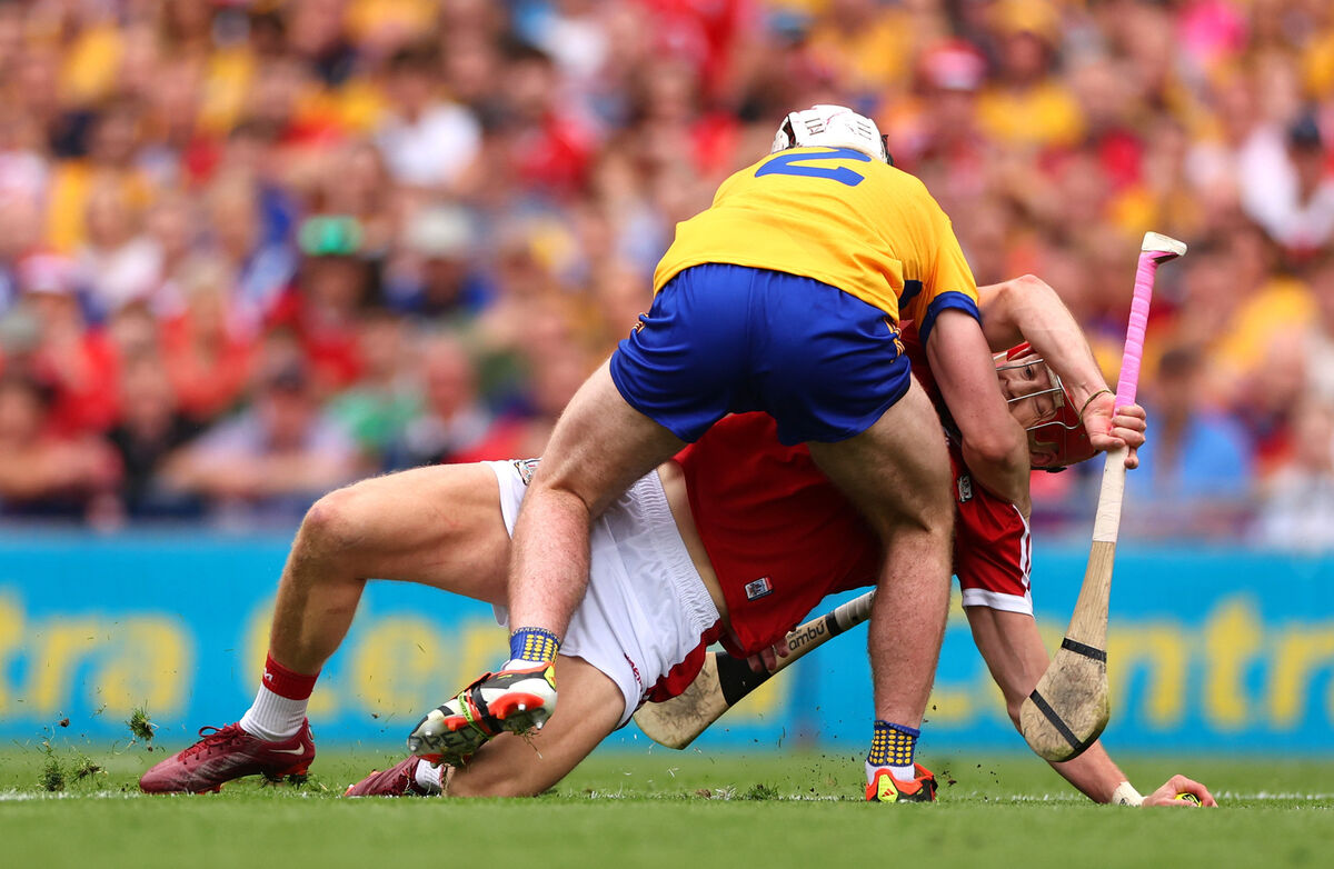 Clare’s Adam Hogan ties up Alan Connolly of Cork. Picture: INPHO/James Crombie
