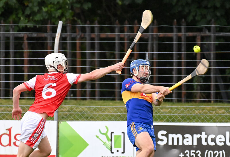 Carrigaline's Rob O'Shea shoots under pressure from Watergrasshill's Ian O'Callaghan. Picture: David Keane. Carrigaline's Rob O'Shea shoots under pressure from Watergrasshill's Ian O'Callaghan. Picture: David Keane.