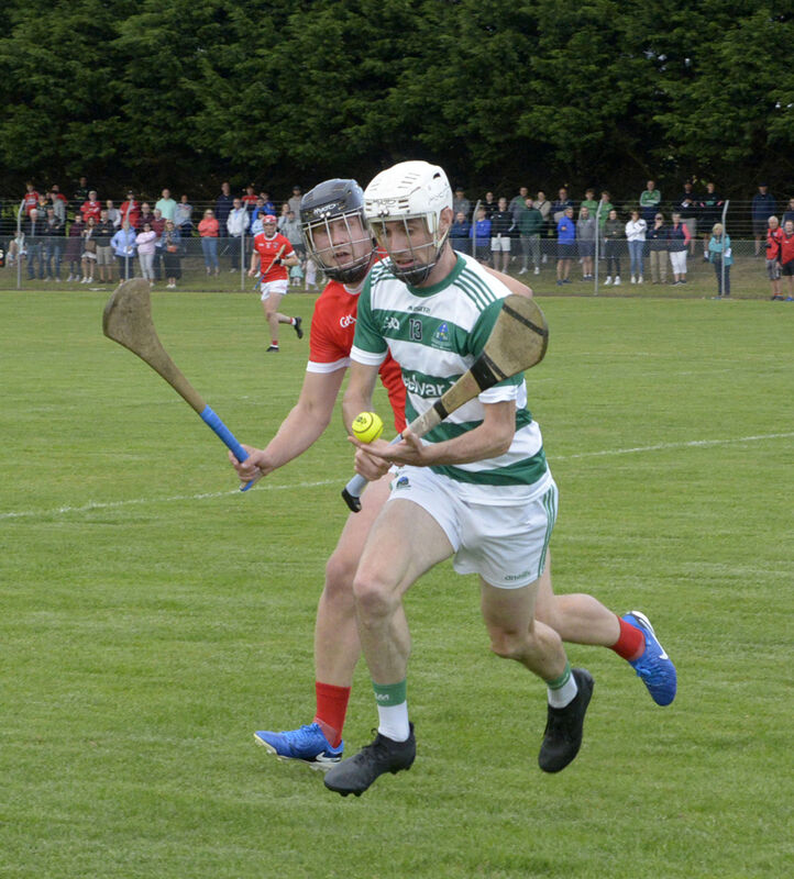 Valley Rovers' Eoin O'Reilly breaks from Castlemartyr's Mike Cosgrave. Picture: Denis Boyle
