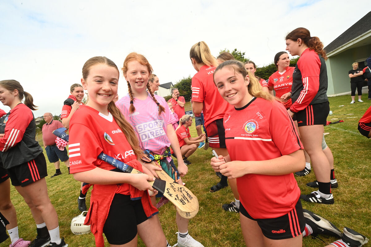  Young supporters Sarah Roche and Hannah Donovan with Cork player Emily O'Donoghue (Bishopstown) signing their hurleys at Aghabullogue GAA Club at Coachford, during the meet and greet session with the Cork intermediate camogie team on Saturday August 3.rd 2024. Pic Larry Cummins
