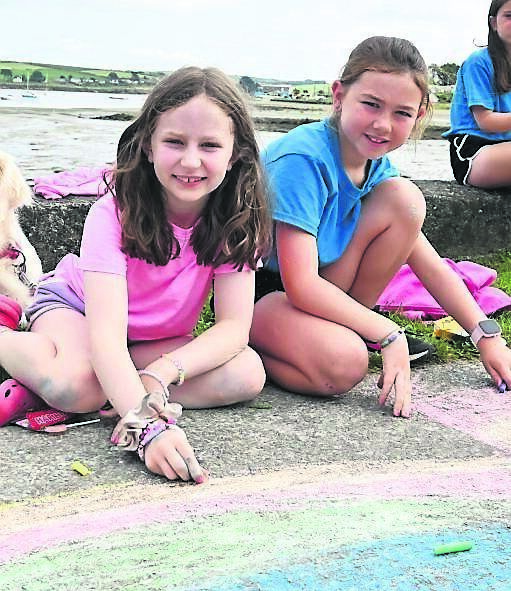 Lily Mehigan, Bandon, and Hayley O’Shea, Douglas, taking part in a chalk drawing competition at the Courtmacsherry Harbour Festival.	Picture: Martin Walsh
                    