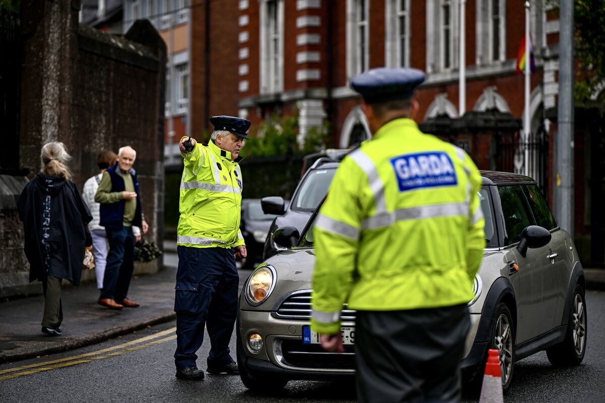  Garda Finbarr Walsh directs traffic at a Garda checkpoint on Sharman Crawford Street in Cork city on Monday, part of a major road safety campaign run by the Gardaí this bank holiday weekend. Picture: Chani Anderson.