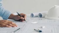 Close-up Of Engineer Hand Drawing Plan On Blue Print with architect equipment,architectural plan, sketching a construction proje
