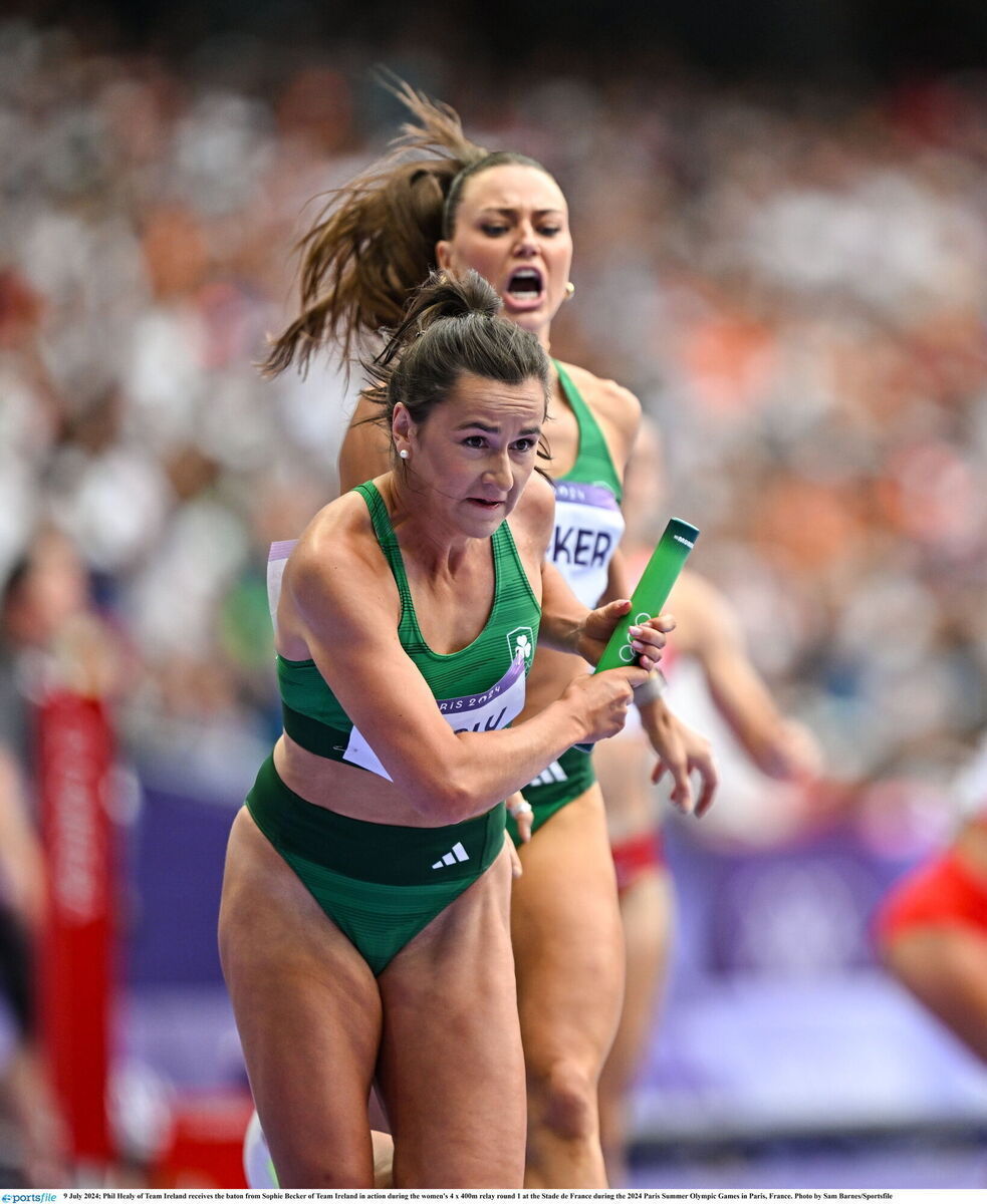 Phil Healy of Team Ireland receives the baton from Sophie Becker. Picture: Sam Barnes/Sportsfile
