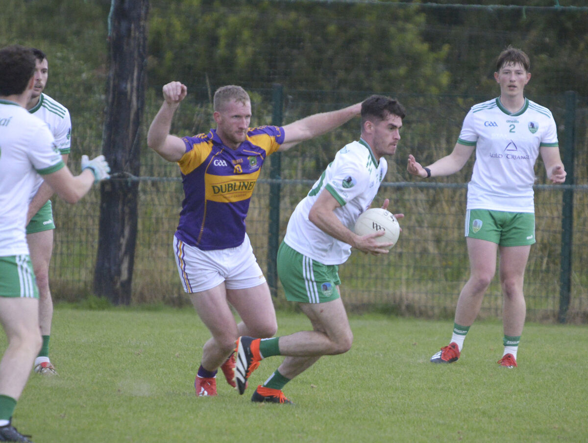 Mark Corrigan brings the ball out of defence for Muskerry. Picture: Denis Boyle