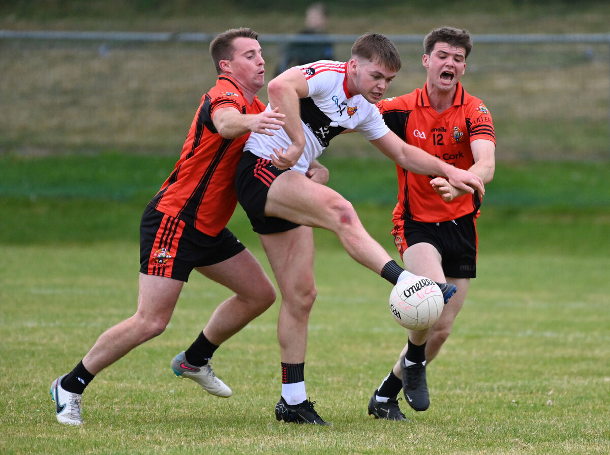 UCC's Cathail O'Mahony gets the ball away from Duhallow's Kevin Cremin and Mikey McAuliffe. Picture: Eddie O'Hare