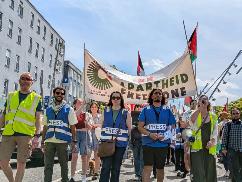 Protestors wearing blue press vests highlight the deaths of journalists in Gaza