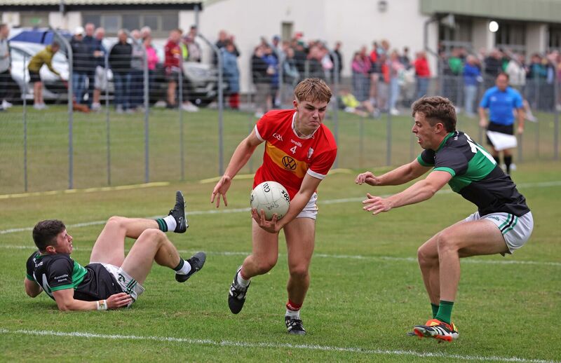 Colm Clifford of Éire Óg tries to evade Nemo Rangers pair Mark Cronin and Ross Corkery. Picture: Jim Coughlan