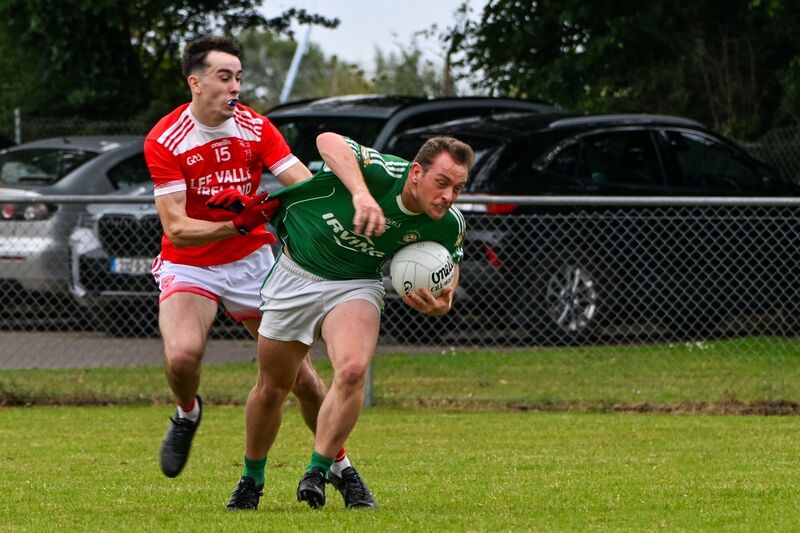 Aghada's Ed Leary is held back by Iveleary's Ian Jones. Picture: Chani Anderson