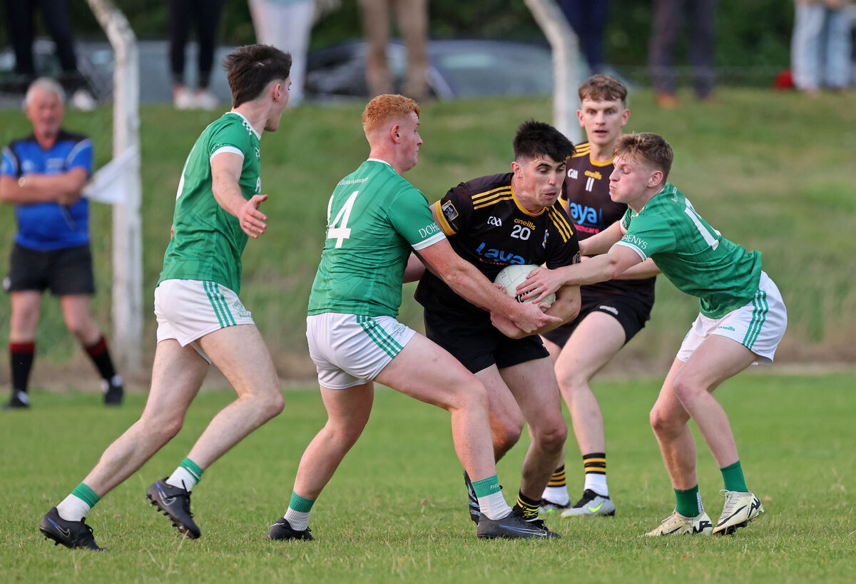 Dohenys' Adam O'Donovan, Gavin Farr and Shane Barry put the pressure on Martin Brennan of Fermoy. Picture: Jim Coughlan