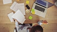 Overhead view of businesswoman working at desk