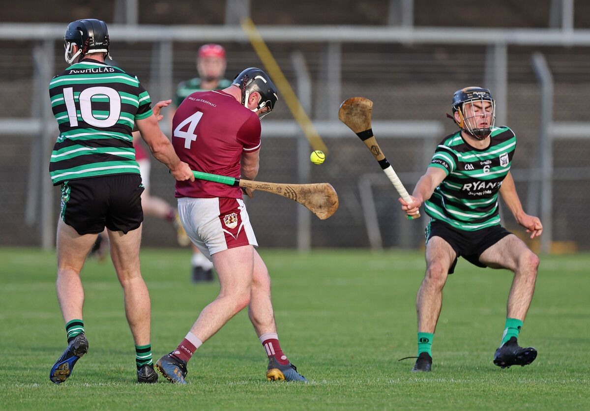  Joseph Harte and Mark Howell of Douglas try to halt the progress of Bishopstown's Conor O'Hora. Picture: Jim Coughlan