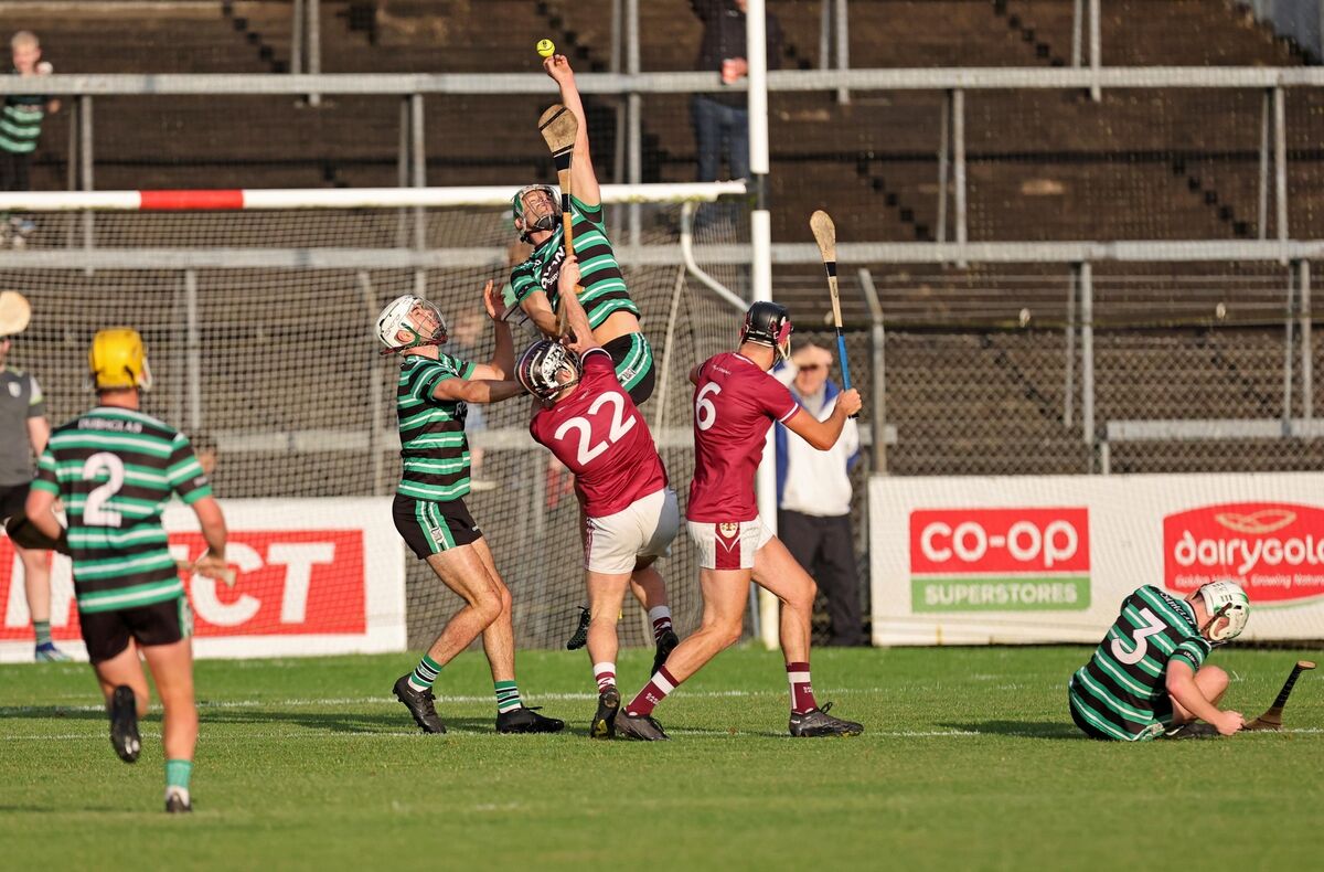  David Kelly and Eoin Cadogan of Douglas, battle for the high ball with David Quaid and Conor Dunne of Bishopstown. Picture: Jim Coughlan