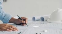Close-up Of Engineer Hand Drawing Plan On Blue Print with architect equipment,architectural plan, sketching a construction proje