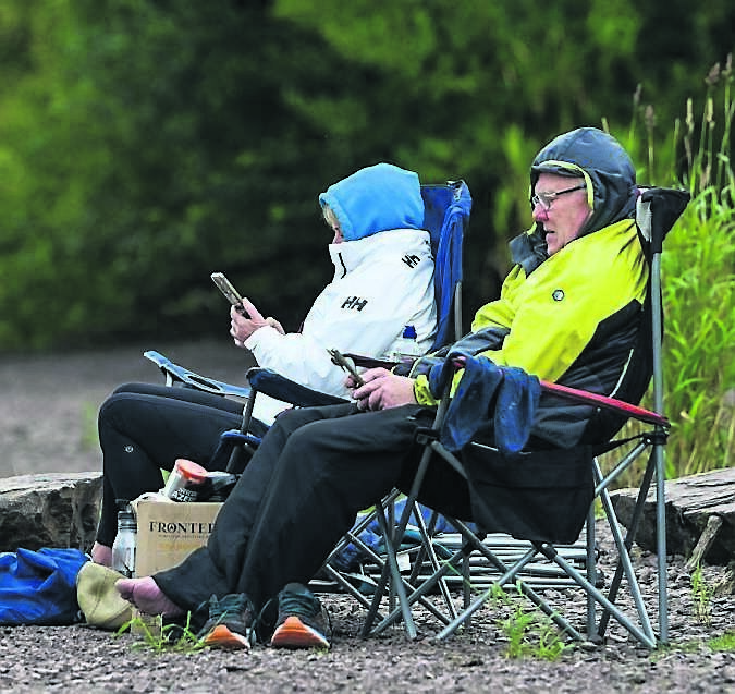 Prepared for all weather (and they needed to be!), spectators watch the racing at the Irish Coastal Rowing Championships in Farran.	 Picture: Chani Anderson