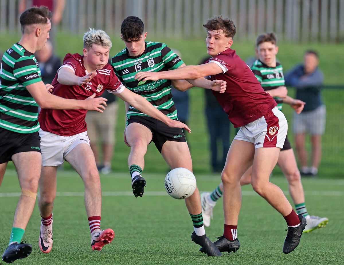  Se Riain Clarke and Gary Holland, Bishopstown, put the pressure on Donnacha Reddington and Padraaig McGrath, Douglas. Picture: Jim Coughlan.