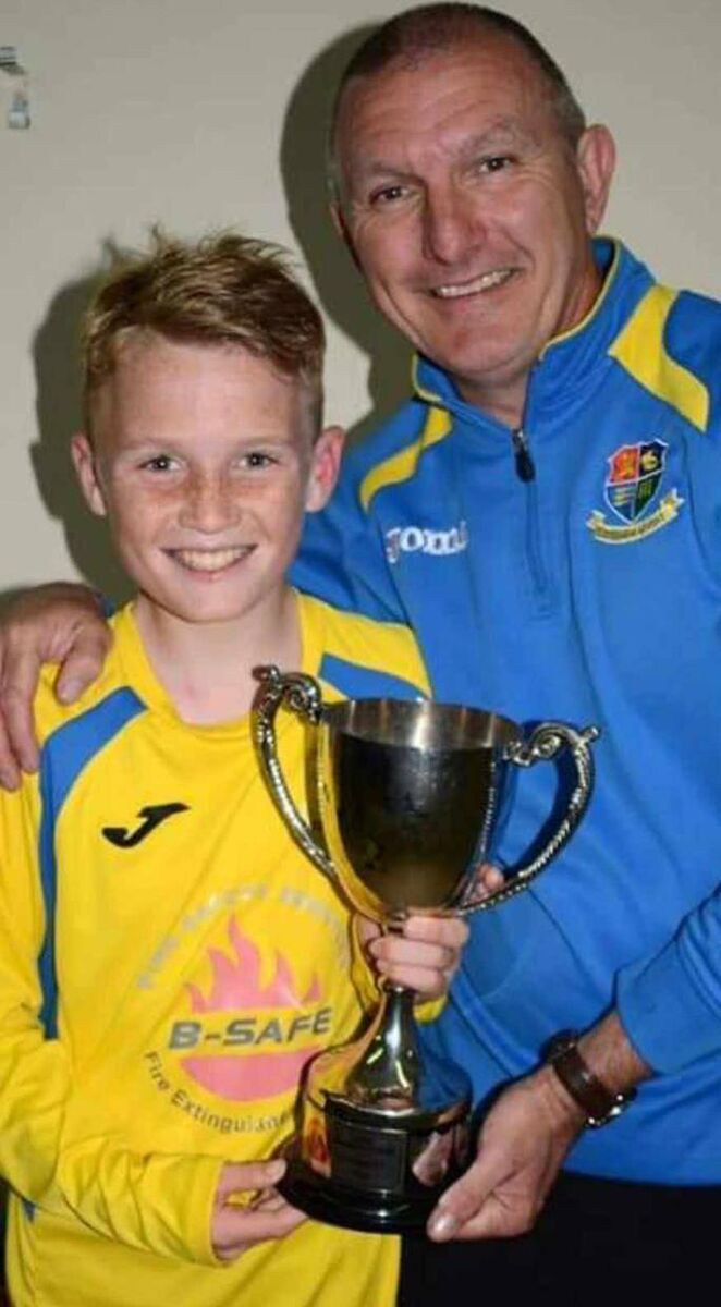 Mark O'Mahony after landing a trophy with Carrigaline, and his dad Paul.