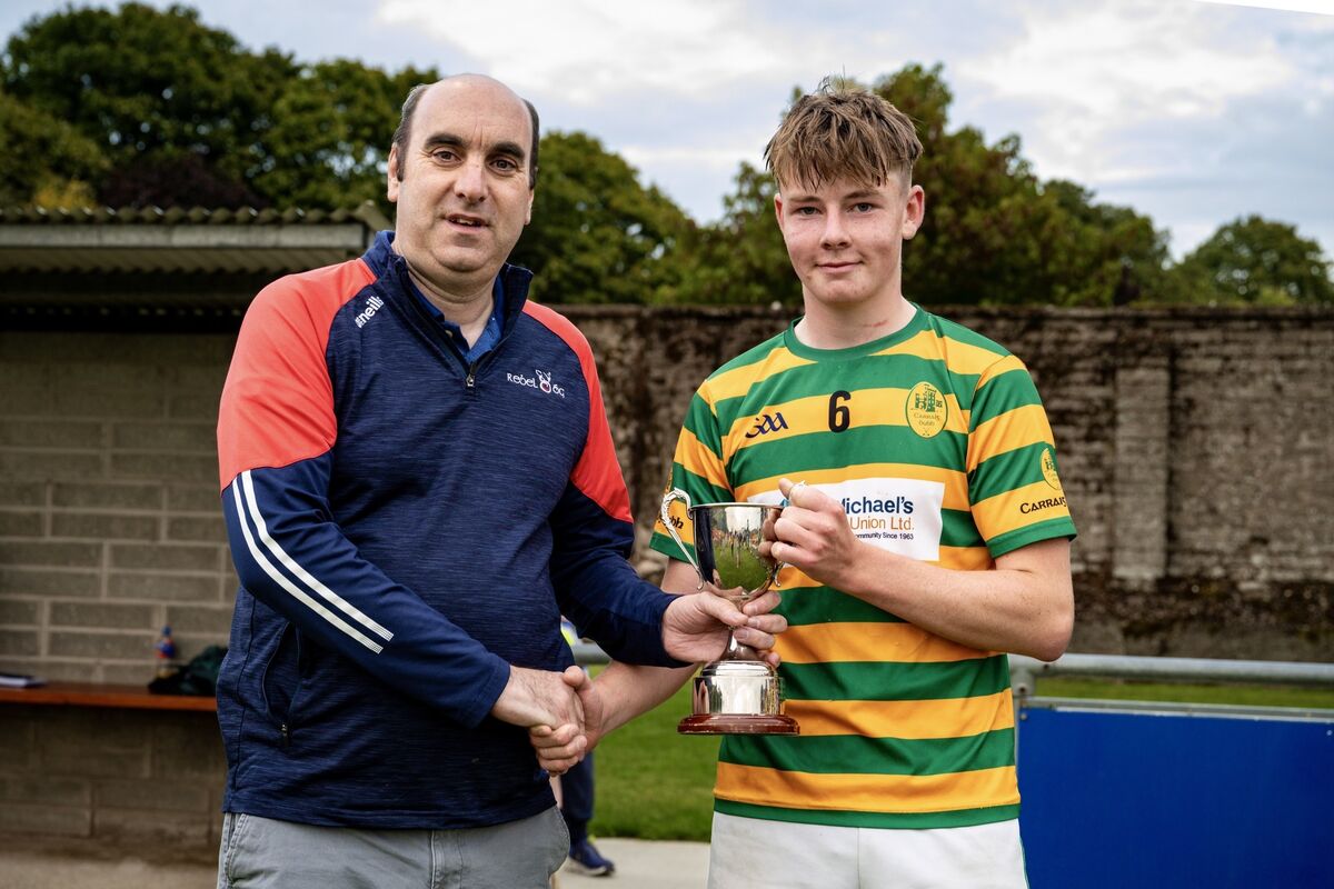 Rebel Óg’s Steven Lynch presents the cup to Blackrock captain Michael Lynch. Picture: Chani Anderson Rebel Óg’s Steven Lynch presents the cup to Blackrock captain Michael Lynch. Picture: Chani Anderson