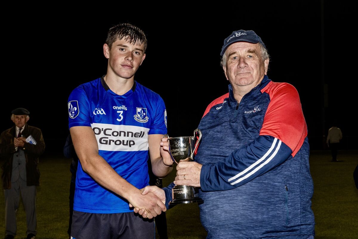 Rebel Óg’s Martin O’Brien presents the cup to Tom O’Brien. Picture: Chani Anderson
