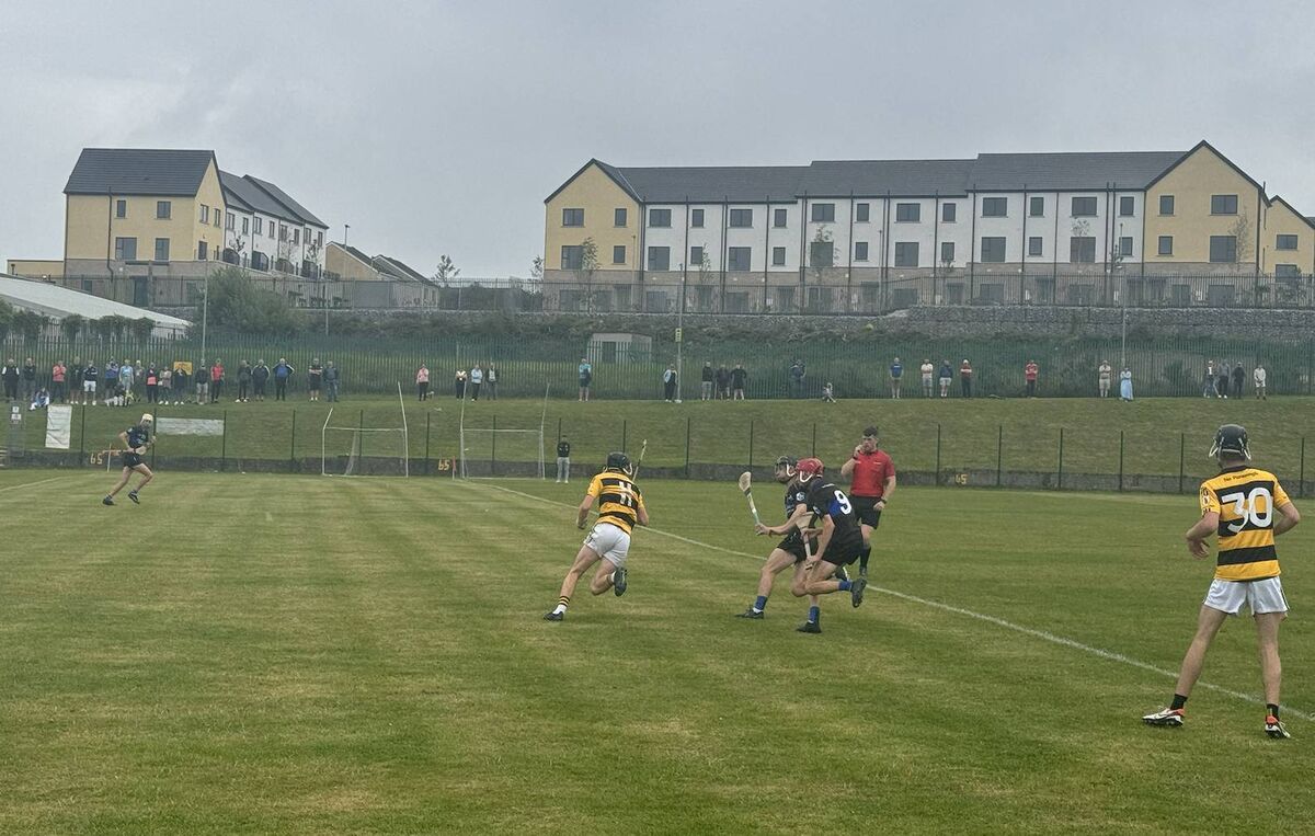 Na Piarsaigh's Craig O'Sullivan evades the challenges of Sarsfields' Adam Leahy and Cuan McMahon.