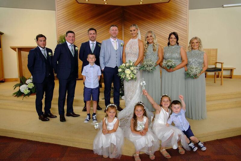 The couple with their wedding party, which was made up of family and friends. They had around 145 guests join in their celebrations.