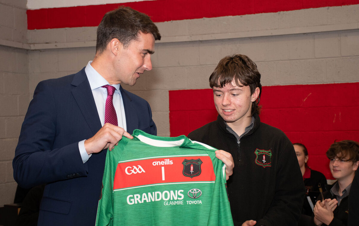 Minister Jack Chambers TD, receives a school GAA jersey from Shay O'Donnchu during his recent visit to Coláiste an Phiarsaigh in Glanmire. Picture: Howard Crowdy Minister Jack Chambers TD, receives a school GAA jersey from Shay O'Donnchu during his recent visit to Coláiste an Phiarsaigh in Glanmire. Picture: Howard Crowdy
