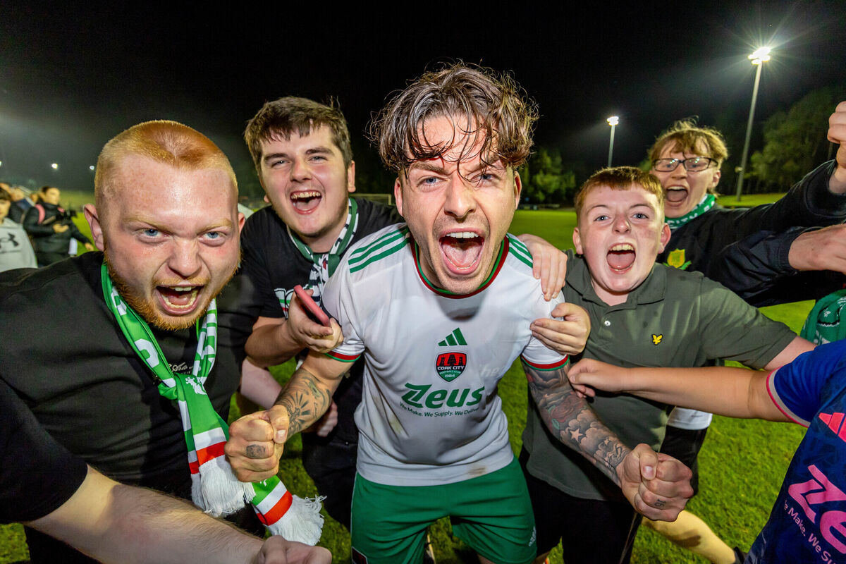 Cork’s Ruairi Keating celebrates winning the First Division and getting promoted to the Premier Division with fans