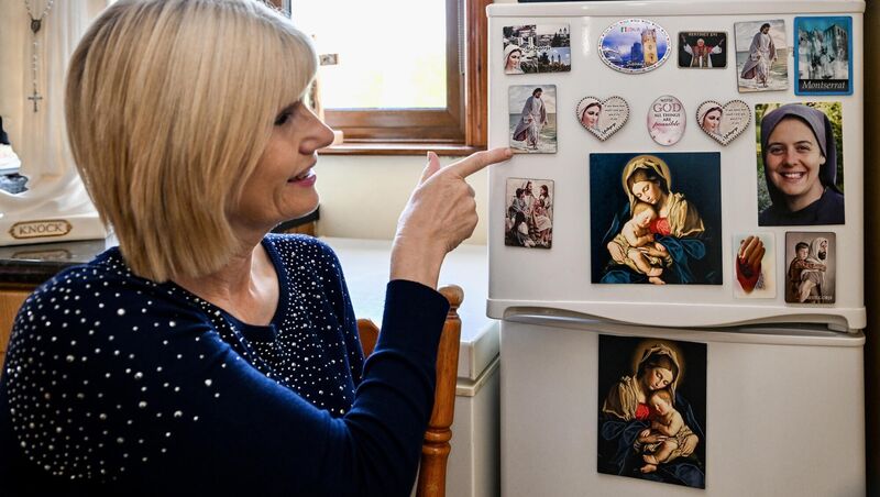 Mary Burke pictured with her collection of religious fridge magnets. Picture Chani Anderson Mary Burke pictured with her collection of religious fridge magnets. Picture Chani Anderson