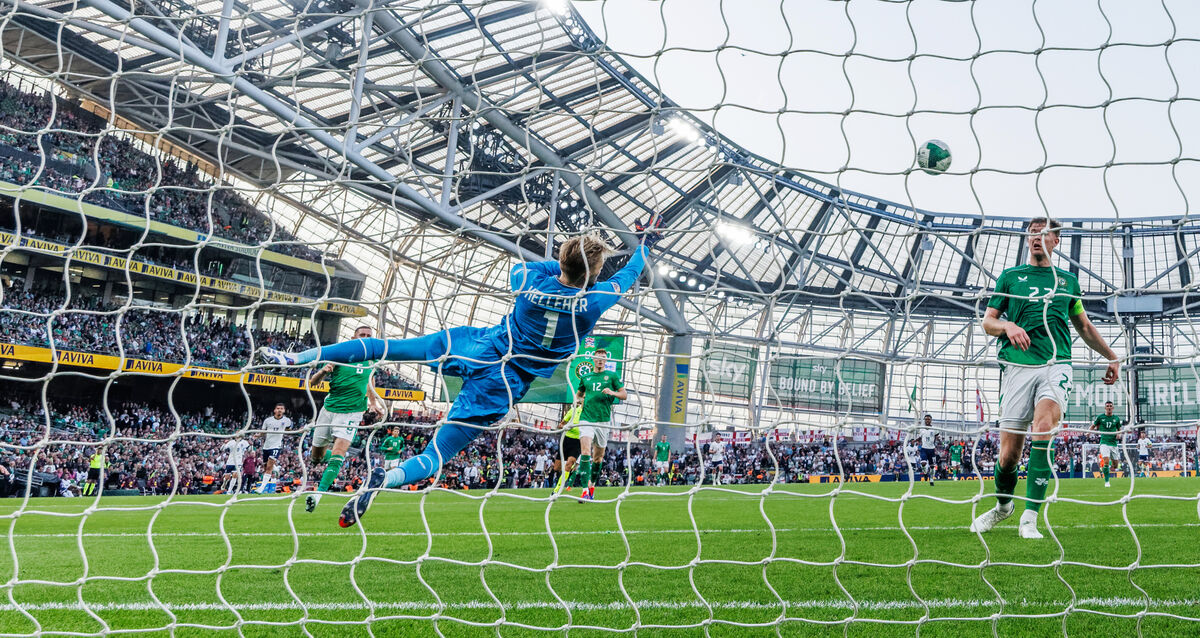 Ireland’s Caoimhin Kelleher makes a save from Bukayo Saka of England