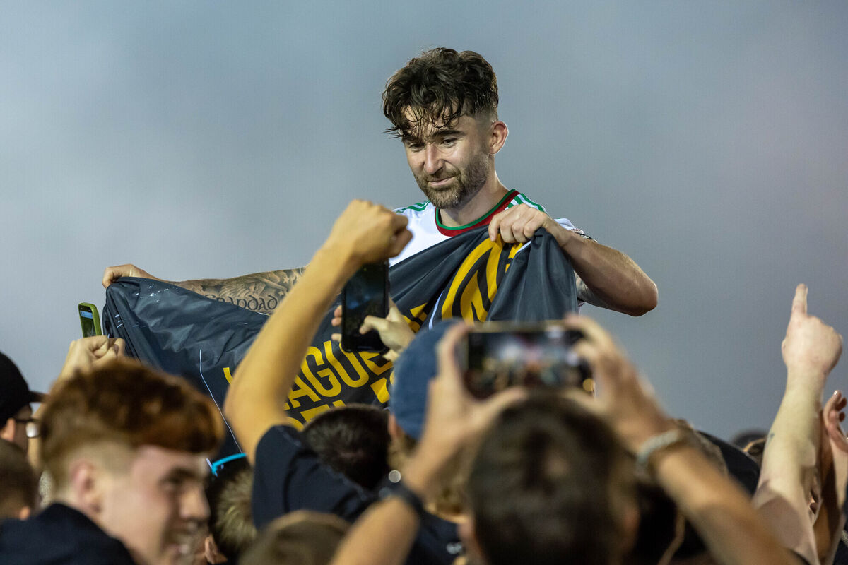 Cork’s Sean Maguire celebrates winning the First Division and getting promoted to the Premier Division with fans