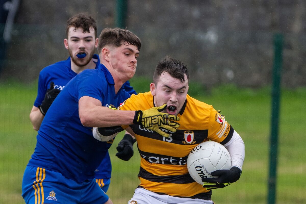 Na Piarsaigh's Kevin O’Meara is held back by St Finbarr's Tómas O’Keeffe during the IAFC match in Mayfield. Picture: Chani Anderson
