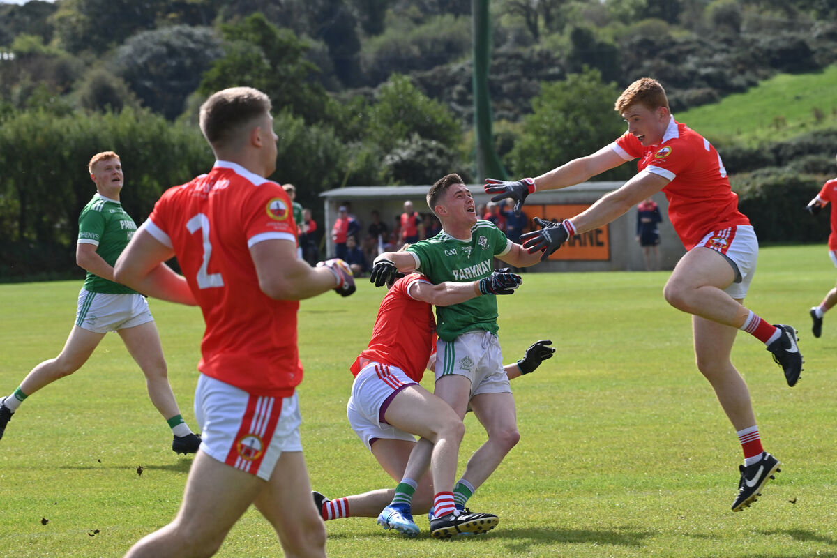 Dohenys' Jerry Farrell is tackled to the ground by Padraig O'Neill as Sean Fitzgerald of O'Donovan Rossa comes in during their McCarthy Insurance SAFC match at Rossmore. Picture: Dan Linehan