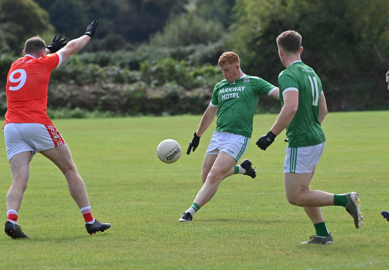  Gavin Farr, Dohenys, putting the ball over the bar for a point watched by David Shannon, O'Donovan Rossa. Picture: Dan Linehan