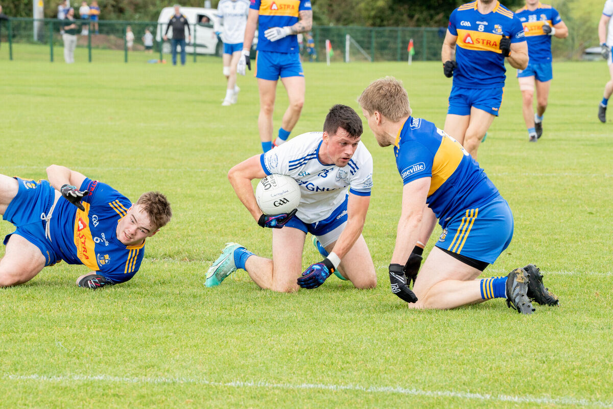 Cill Na Martra's Daniel O Dúinnin holds on to the ball while under pressure from Carrigaline. Picture: Noel Sweeney