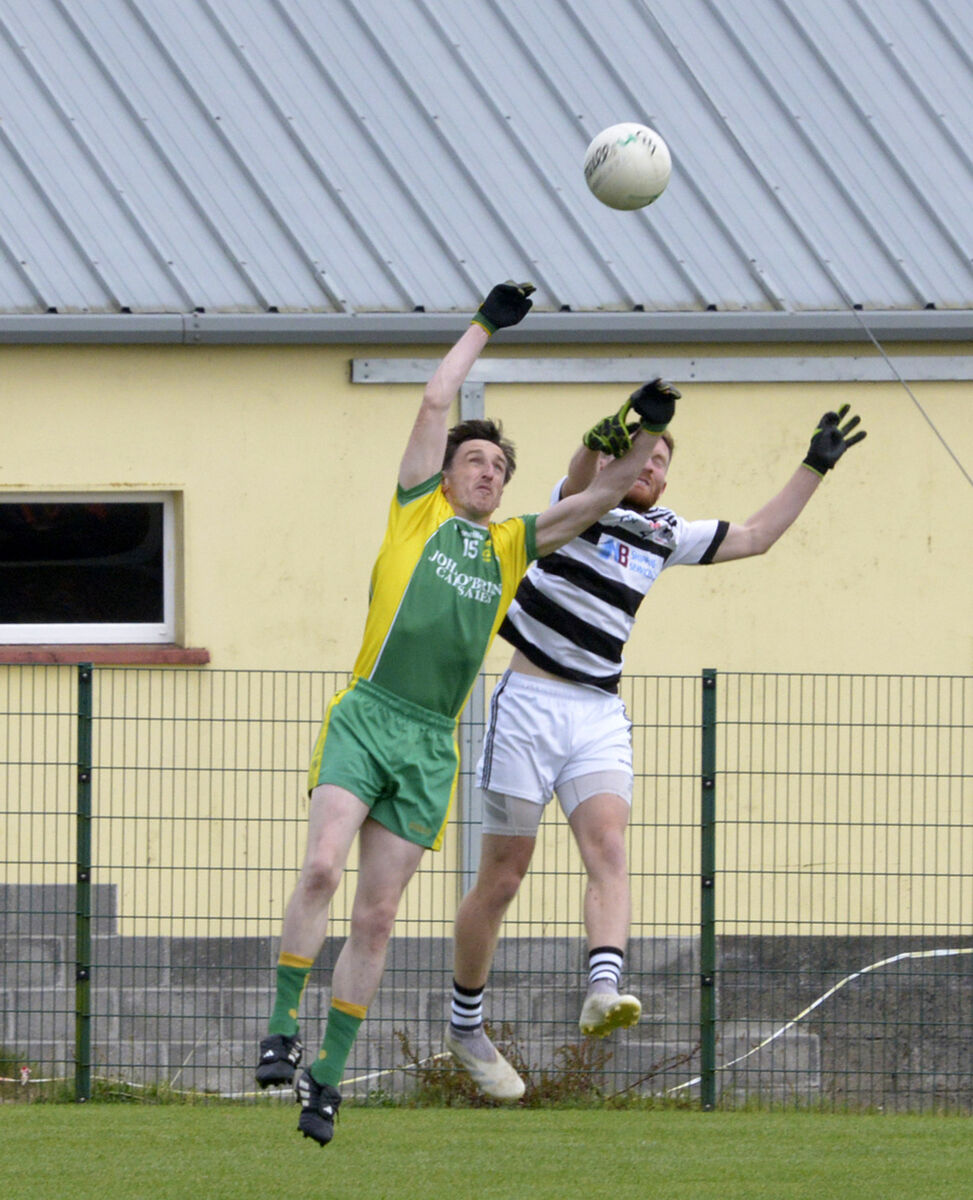 St James' Frank Hayes and St Nicholas' Kenneth McCarthy Coade battle for the ball. Picture: Denis Boyle