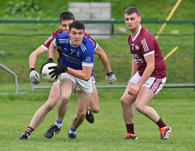 Wayne Mac Cárthaigh, Naomh Abán, getting away from Rockchapel defenders Eamonn O'Callaghan and David Carroll. Picture: Dan Linehan Wayne Mac Cárthaigh, Naomh Abán, getting away from Rockchapel defenders Eamonn O'Callaghan and David Carroll. Picture: Dan Linehan