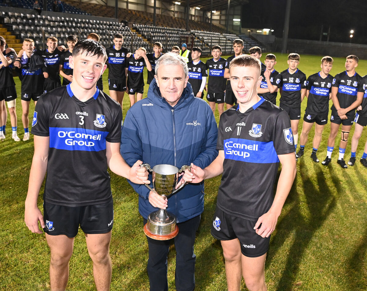 Michael O'Mahony, chairman Rebel Óg presents the trophy to Sarsfields joint captains Tom O'Flynn and Cormac Fennessy after defeating Glen Rovers in the Rebel Óg under 16 Premier 1 HC final at Pairc Ui Rinn. Picture: Eddie O'Hare