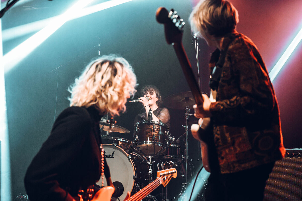 Singer and drummer Julie Landers (middle) puts manners on their bandmates in I Dreamed I Dream.