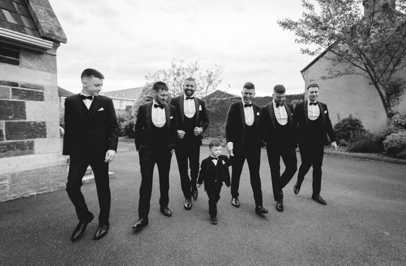 The groom and his wedding party heading to the church.