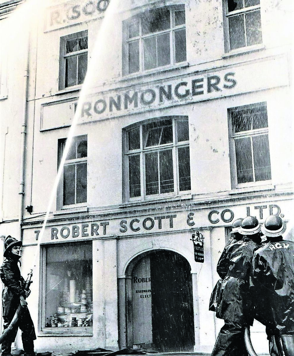 Author of this article, Pat Poland, left, as an 18-year-old member of the city Brigade, looking over at the Harrington and Goodlass Wall volunteer firefighters at Scott’s, St Patrick’s Quay, on February 13, 1965. Author of this article, Pat Poland, left, as an 18-year-old member of the city Brigade, looking over at the Harrington and Goodlass Wall volunteer firefighters at Scott’s, St Patrick’s Quay, on February 13, 1965.