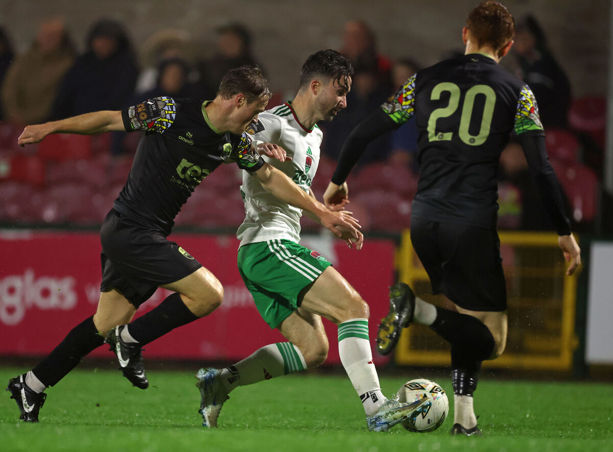  Seani Maguire, Cork City FC, battling Christopher Horgan and Evan O'Connor, Treaty United. Picture: Jim Coughlan.