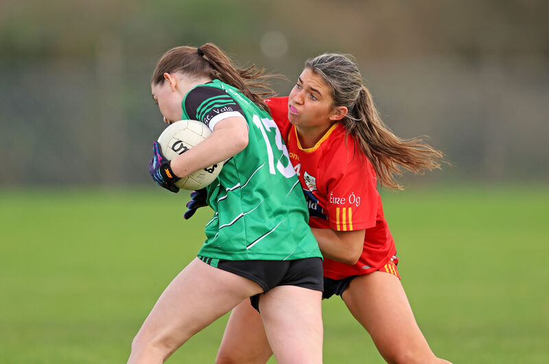  Amy Sheppard, St Val's, tries to get Shauna Sheehan, Éire Óg. Picture: Jim Coughlan.